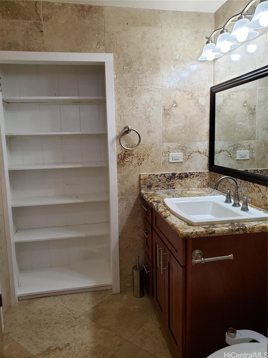 3403 Ala Ilima Street Honolulu, HI 96818 - Photo 19 of 23 a bathroom with a granite countertop sink and a mirror