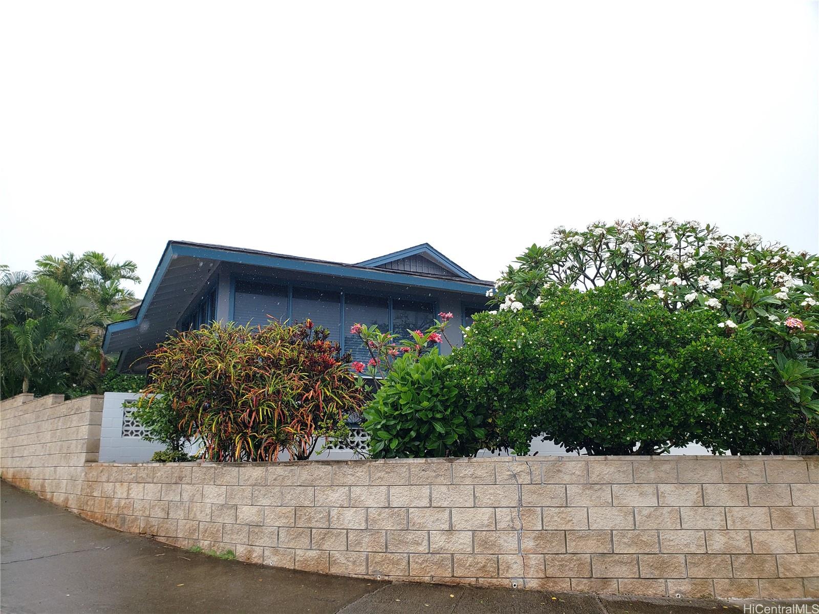 3403 Ala Ilima Street Honolulu, HI 96818 - Photo 2 of 23 a view of a house with a small yard and plants