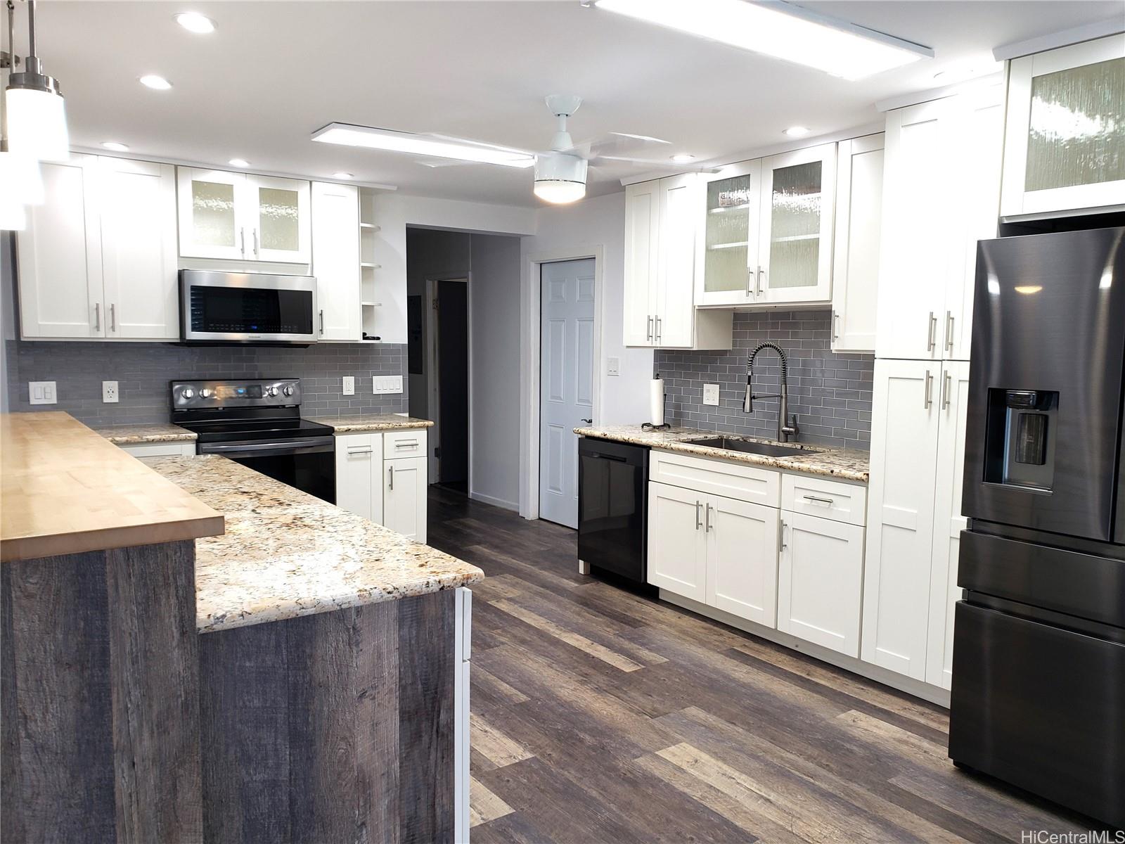 3403 Ala Ilima Street Honolulu, HI 96818 - Photo 4 of 23 a kitchen with a refrigerator stove and sink