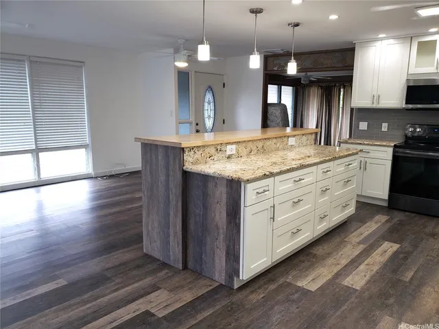 a bathroom with a granite countertop sink and a large mirror