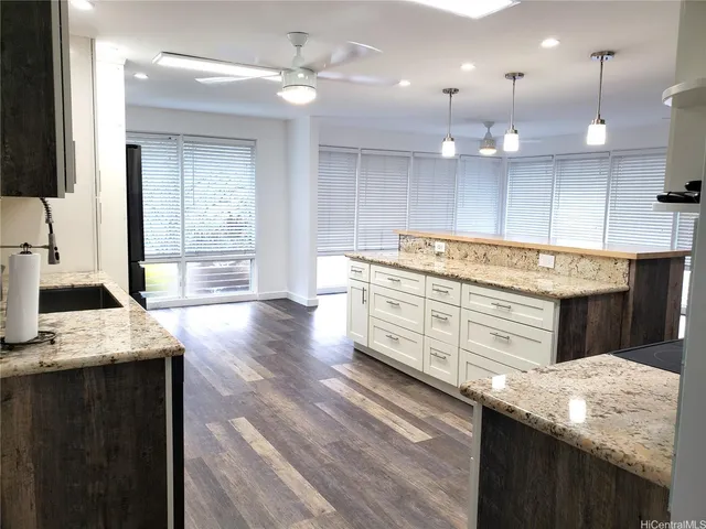 a kitchen with a stove a sink and a refrigerator
