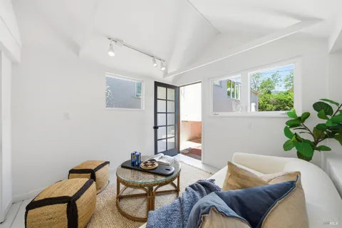 a view of a house with backyard and sitting area