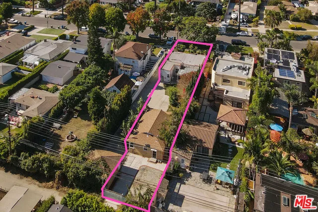 an aerial view of residential houses with outdoor space