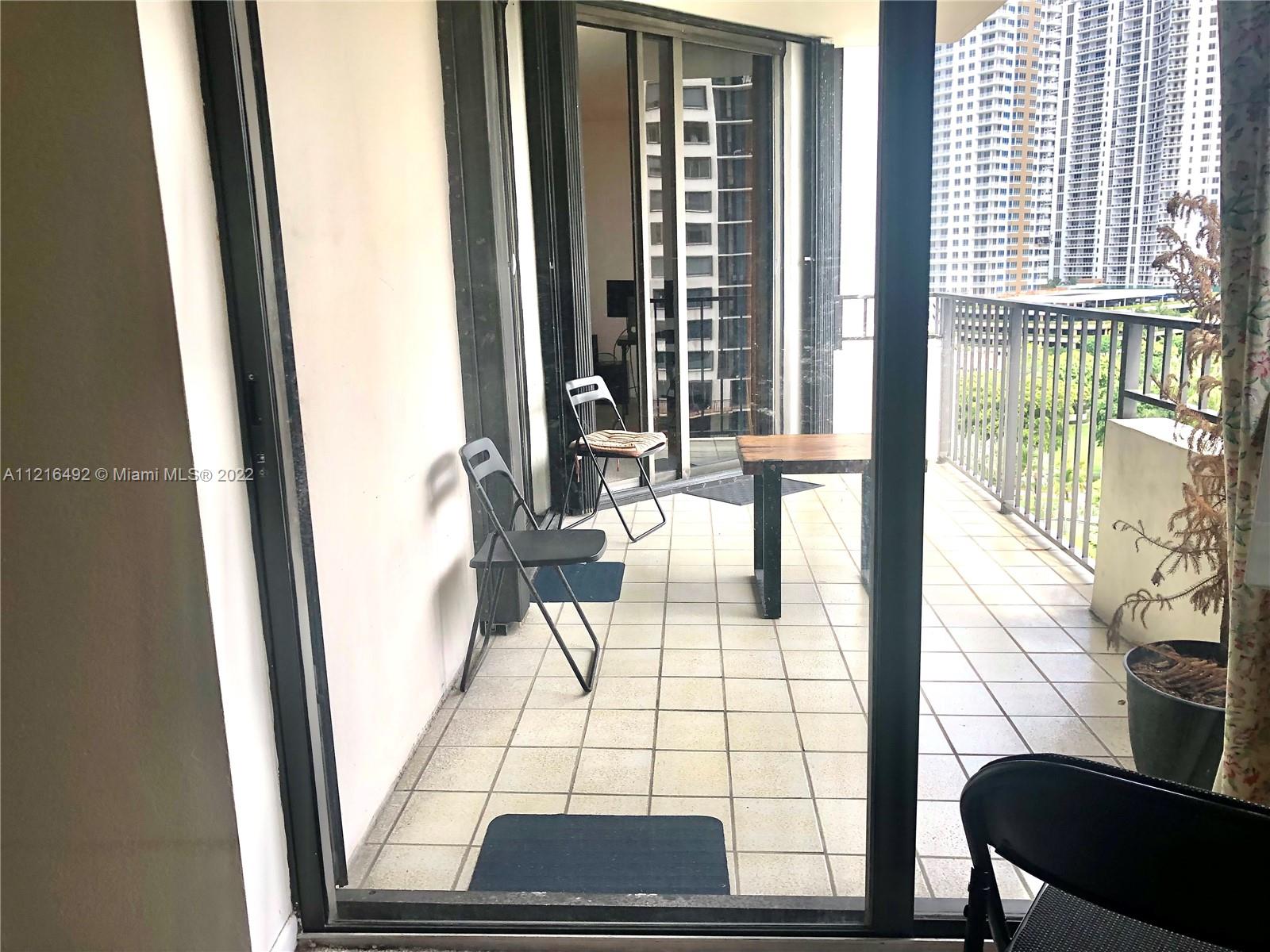 520 Brickell Key Drive, Unit A1102 Miami, FL 33131 - Photo 12 of 20 a view of a living room with a floor to ceiling window