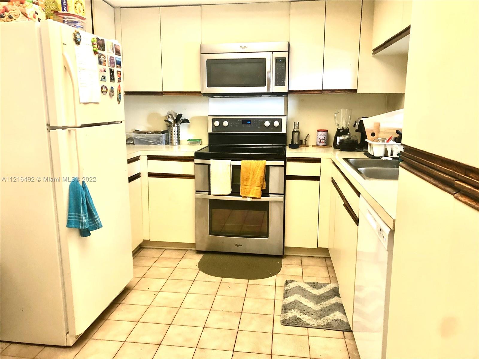 520 Brickell Key Drive, Unit A1102 Miami, FL 33131 - Photo 3 of 20 a kitchen with a sink a stove and a refrigerator