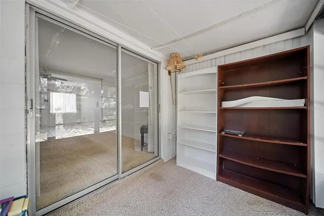 a view of a backyard with swimming pool and sitting area