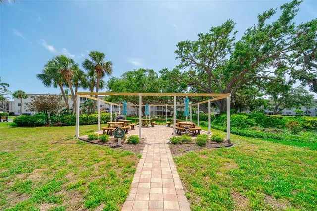 a view of a swimming pool with a patio and a yard