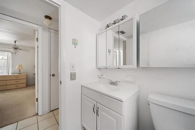 a view of a livingroom with a ceiling fan and window
