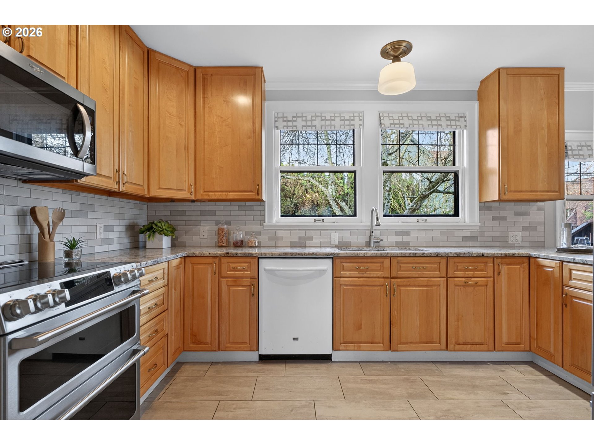 6971 North Vincent Avenue Portland, OR 97217 - Photo 16 of 48 a kitchen with stainless steel appliances granite countertop a stove a sink and a microwave