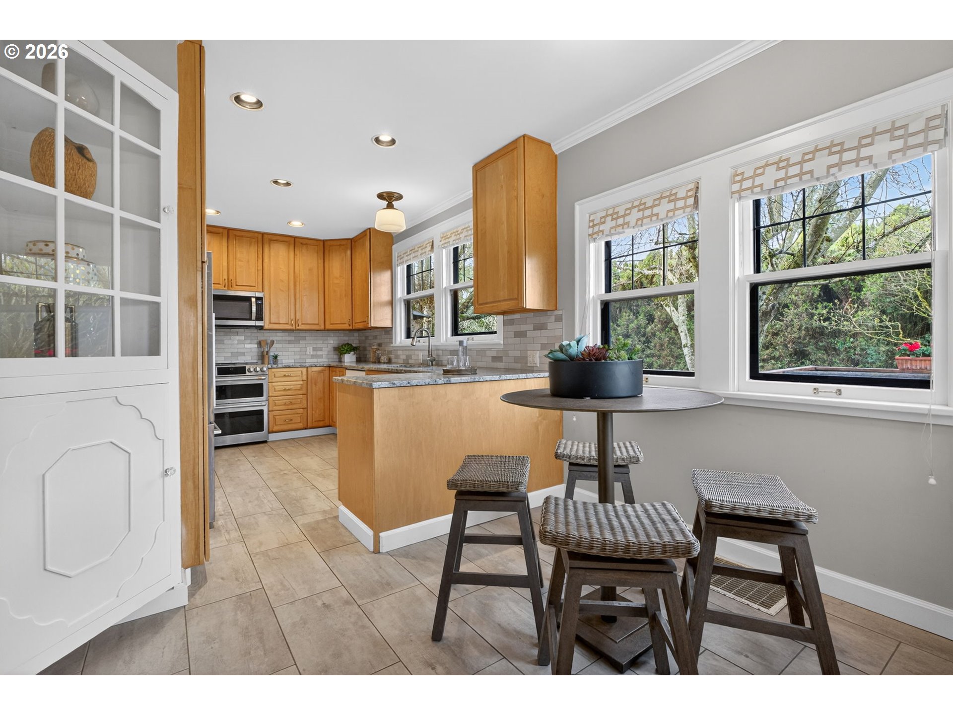 6971 North Vincent Avenue Portland, OR 97217 - Photo 18 of 48 a kitchen with a table chairs refrigerator and cabinets