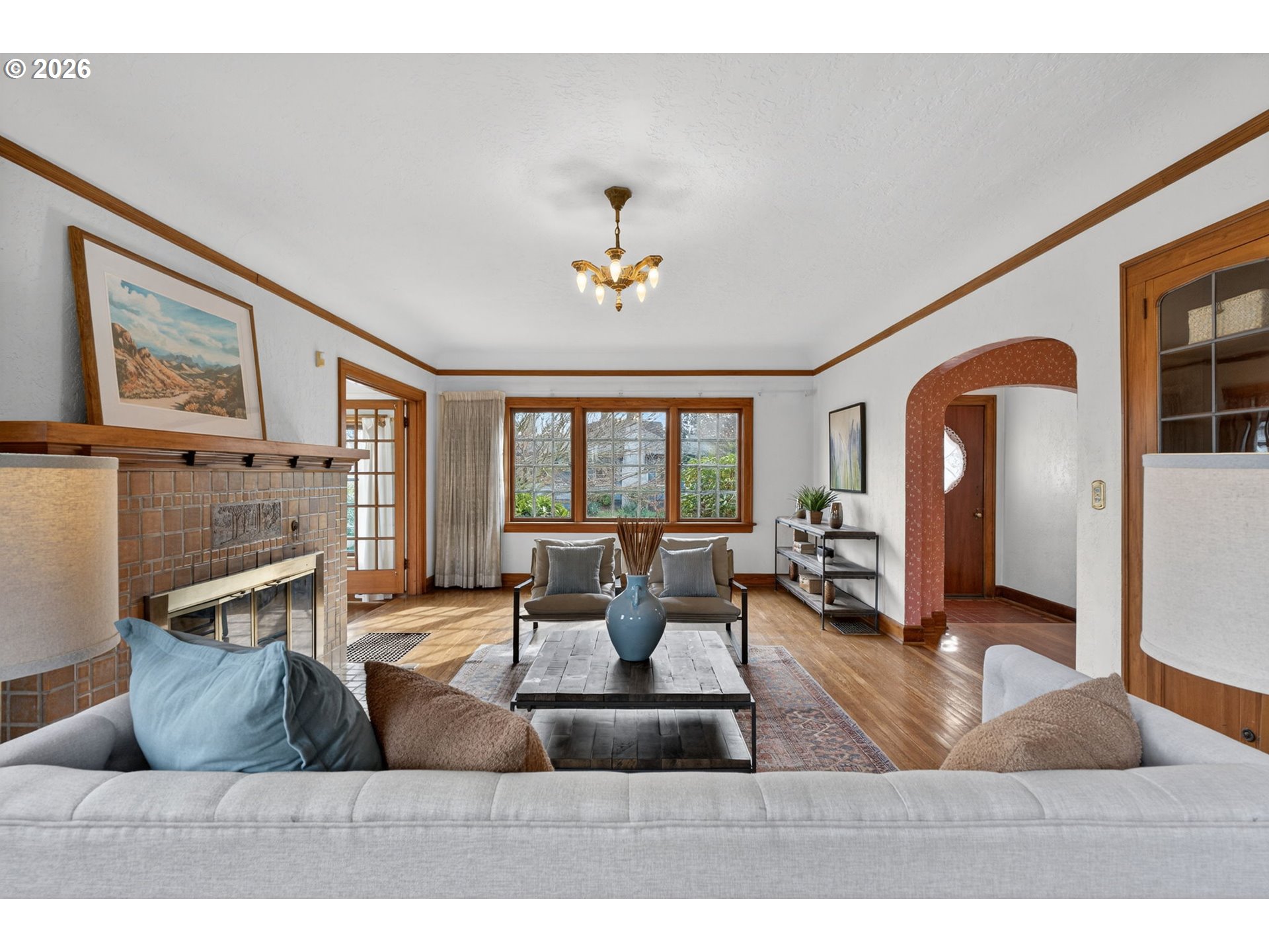 6971 North Vincent Avenue Portland, OR 97217 - Photo 8 of 48 a living room with furniture a fireplace and large windows