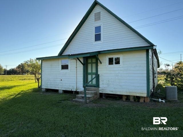 26128 County Road 49 Loxley, AL 36551 - Photo 2 of 6 Rear view of house with entry steps and a lawn