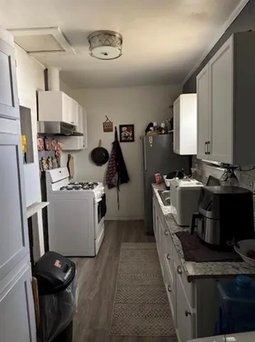 a kitchen with a sink appliances and cabinets