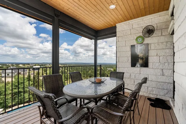 a view of a balcony with table and chairs