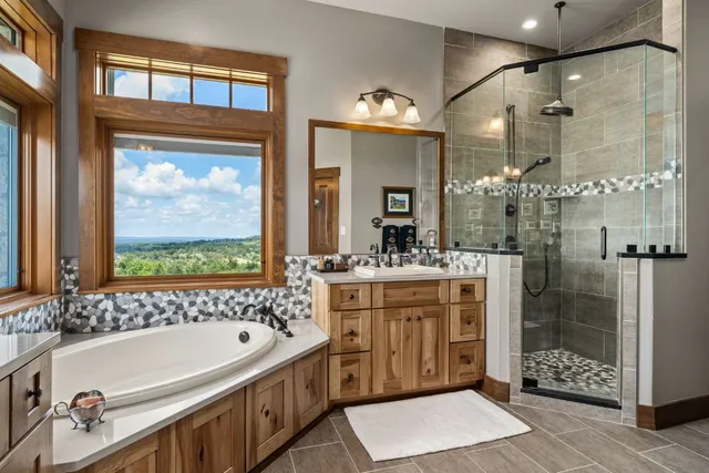 a bathroom with a double vanity sink mirror and shower