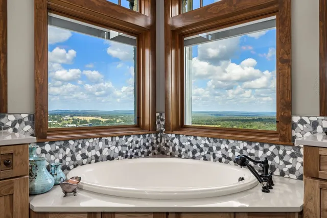 a bathroom with a bathtub and a painting on the wall