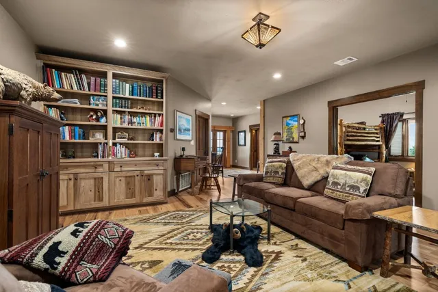 a living room with furniture and a book shelf