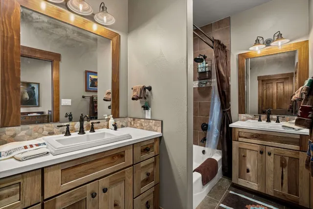 a bathroom with a double vanity sink and mirror