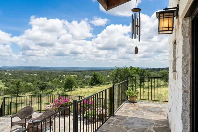 a view of a balcony with a yard