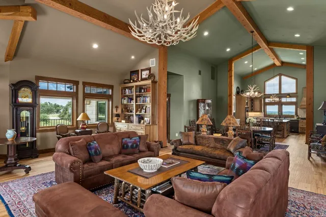 a living room with furniture and a chandelier