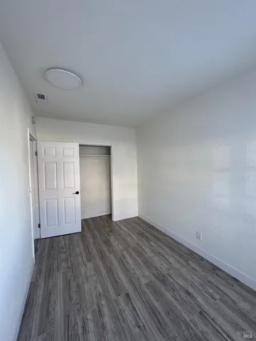 a view of an empty room and wooden floor
