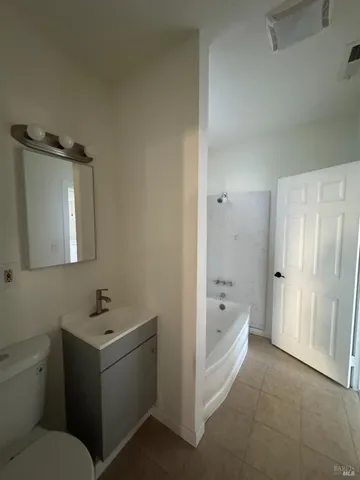 a bathroom with a bathtub and toilet