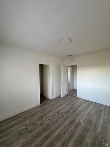 a view of an empty room and wooden floor