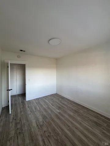 a kitchen with a sink a microwave and cabinets