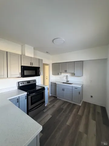 a kitchen with sink cabinets and window