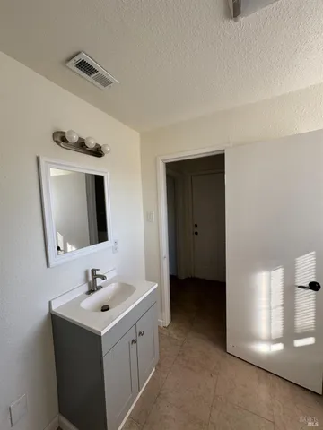 a view of an empty room and wooden floor