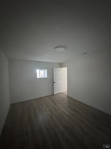 a view of an empty room and wooden floor