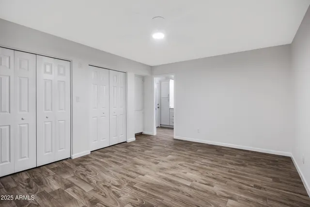 a bathroom with a double vanity sink and mirror with shower