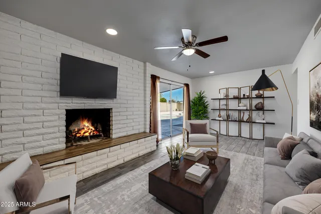 a living room with furniture a flat screen tv and a fireplace