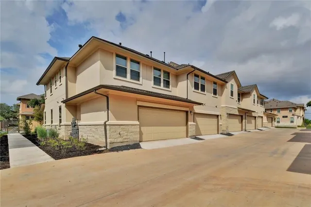 a front view of a house with a street