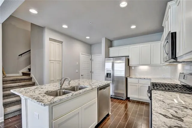 a kitchen with a sink stove and refrigerator