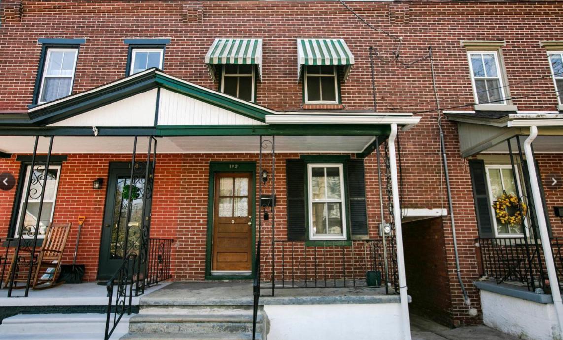Charming brick facade with awnings.
