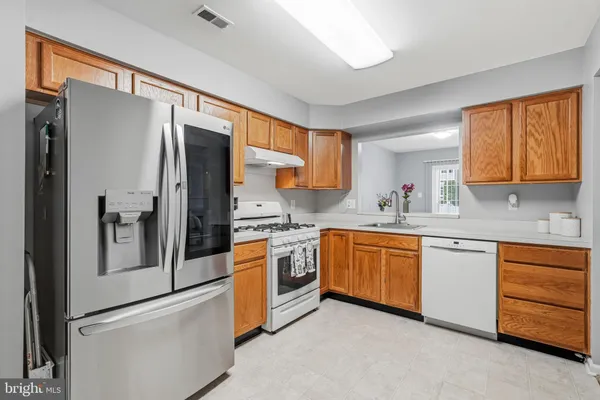 a kitchen with stainless steel appliances granite countertop a stove and a sink