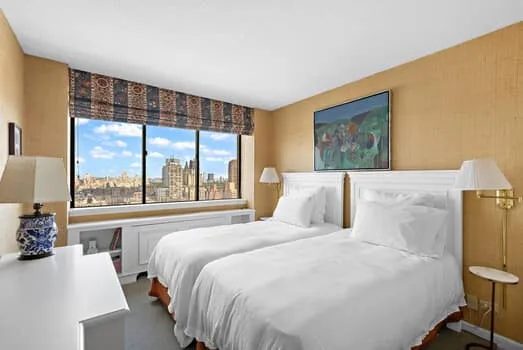 a bedroom with a large bed and a large window