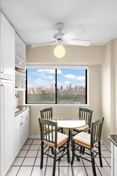 a view of a dining room with furniture a chandelier and wooden floor