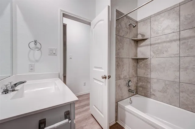 a bathroom with a bathtub and a sink