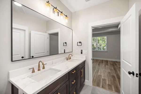 a bathroom with a sink double vanity and a mirror