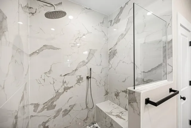 a spacious bathroom with a double vanity sink a large mirror and shower