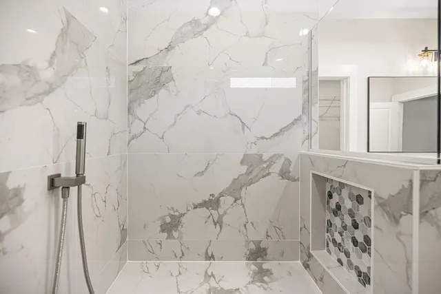 a bathroom with a granite countertop shower toilet and sink
