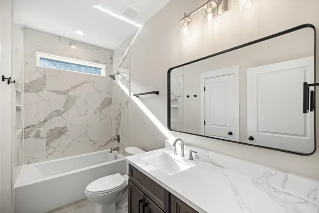 an empty room with wooden floor and fan