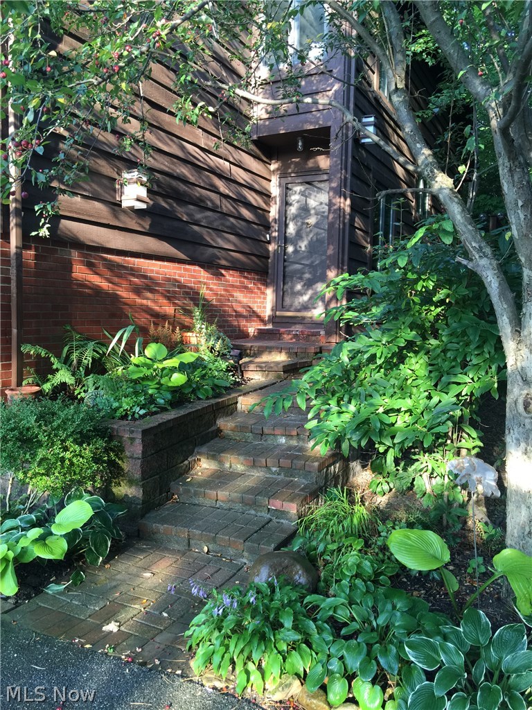 215 Solon Road, Unit D Chagrin Falls, OH 44022 - Photo 2 of 25 Lush landscaped entranceway to the 3 story townhouse