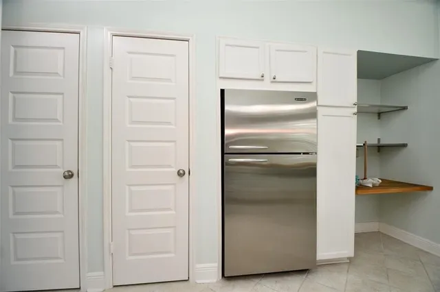 a kitchen with a refrigerator and cabinet