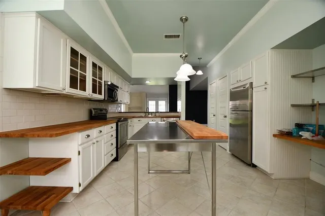 a kitchen with stainless steel appliances granite countertop a sink and a refrigerator