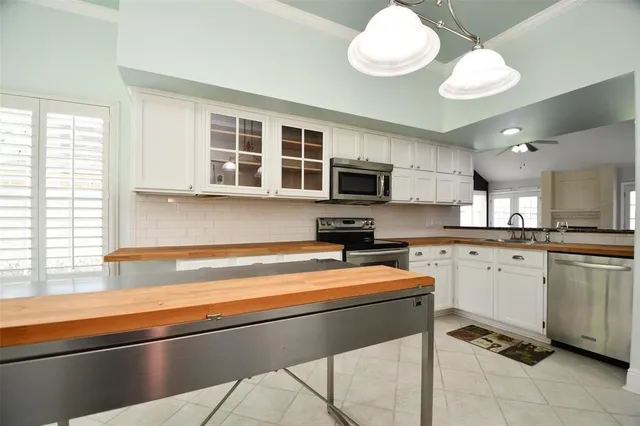 a kitchen with a sink cabinets and window