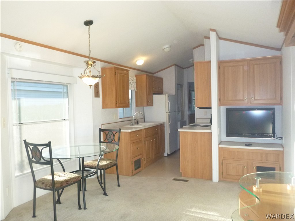 2000 South Ramar Road, Unit 688 Bullhead City, AZ 86442 - Photo 15 of 20 a kitchen with a refrigerator and microwave