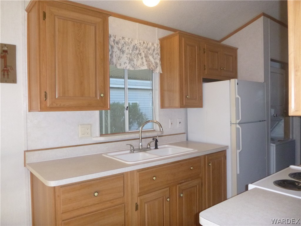 2000 South Ramar Road, Unit 688 Bullhead City, AZ 86442 - Photo 17 of 20 a bathroom with a sink a mirror and a shower